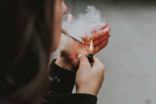 Une femme s'allume une cigarette (illustration).