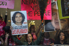 Un manifestant soulevant le portrait d'Ofer Kalderon, otage israélien du 7 octobre 2023