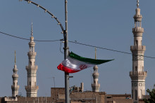 Le drapeau iranien flotte devant une mosquée à Qom, en Iran, avril 2025
