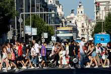 Des piétons traversent la rue Gran Via, dans le centre de Madrid, le 3 juillet 2024.