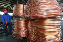 Un employé travaille sur une ligne de fabrication de câbles en cuivre dans une usine de Suzhou, en Chine, le 16 avril 2011.