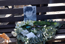 Un bouquet de fleurs et une photos de Medhi Narjissi sur un banc lors d'une cérémonie commémorative à la plage de Dias au Cap de Bonne-Espérance, près du Cap, le 7 août 2025.