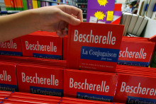 Une jeune fille achète un "Bescherelle", le manuel de conjugaison, le 02 août 2004 dans une grande surface de Rots (Calvados).