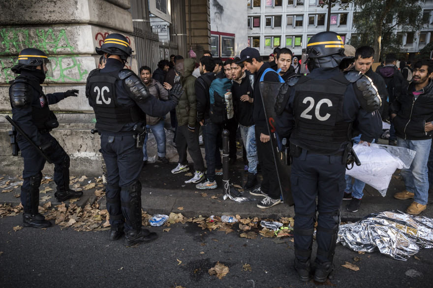Des policiers procèdent à une opération de contrôle auprès des migrants du camp Stalingrad