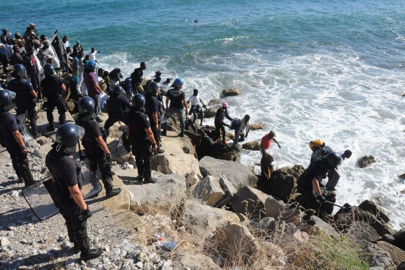 Des migrants à Menton (Alpes-Maritimes), le 5 août, encadrés par les forces de l'ordre.