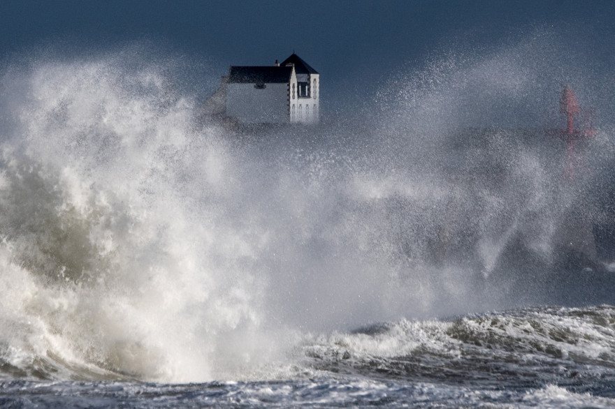 Des vagues s'écrasent sur une jetée dans l'ouest de la France, le 28 décembre 2020, alors que la tempête Bella a provoqué des pluies torrentielles et des vents violents dans une grande partie du pays.